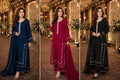 Three women modeling traditional South Asian salwar kameez sets in a grand indoor event hall with warm chandeliers and floral decor. The left set is navy blue, the center set is deep maroon, and the right set is black, each with white embroidered detailing on the neckline and borders.